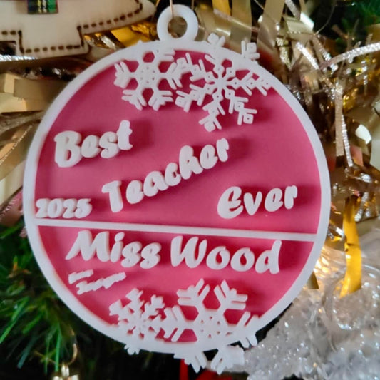 Decorative ornament with 'Best Teacher Ever Miss Wood' text on a pink background with snowflake designs.