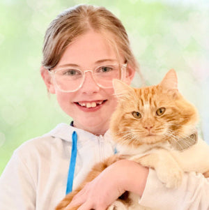 Person holding a cat with a blurred green background